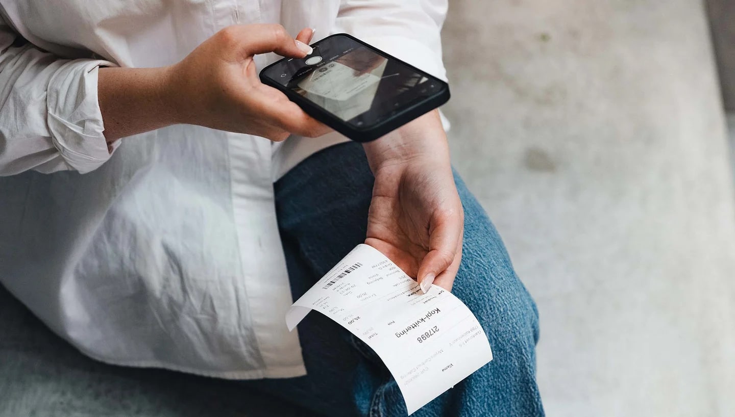 Consumer scanning a purchase receipt with a smartphone